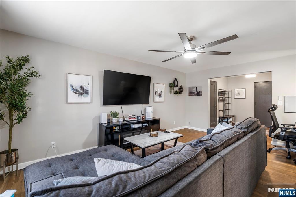 126 Hackett Place, Unit 101A Rutherford, NJ 07070 - Photo 9 of 22 a living room with furniture and a flat screen tv