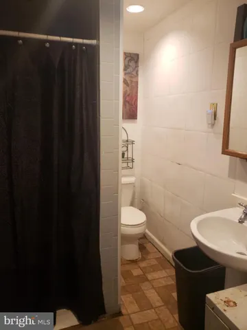 a bathroom with a toilet a sink and shower