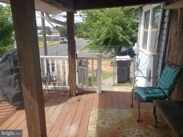 a view of a house with a small yard and a large tree