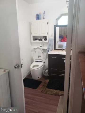 a view of bathroom with a toilet sink and mirror