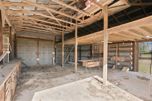 a view of a yard in front of a house with a large tree