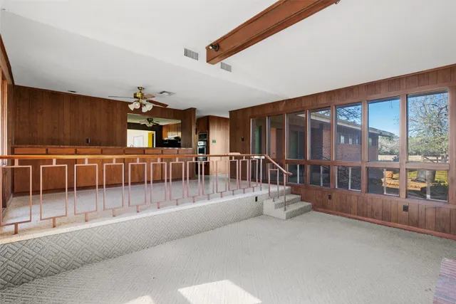 a view of a porch with furniture and floor to ceiling window