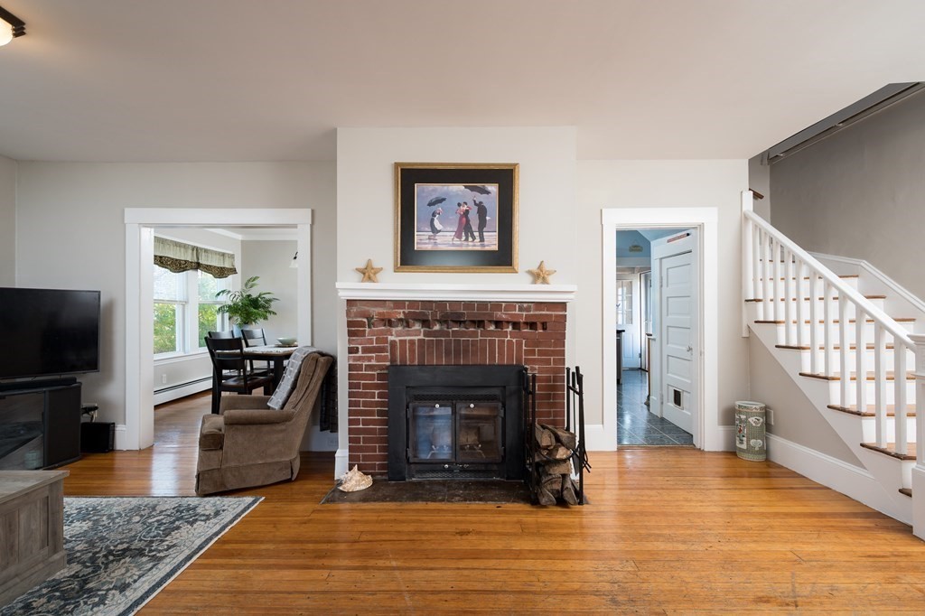 48 Bates Street Hull, MA 02045 - Photo 1 of 31 a living room with furniture and a fireplace