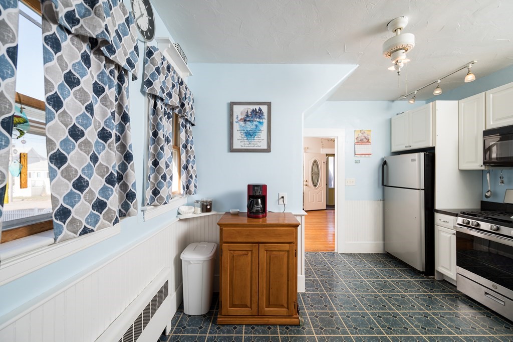 48 Bates Street Hull, MA 02045 - Photo 13 of 31 a kitchen with stainless steel appliances a refrigerator and a stove top oven