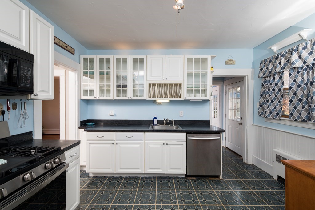 48 Bates Street Hull, MA 02045 - Photo 15 of 31 a kitchen with granite countertop a stove a sink and a refrigerator