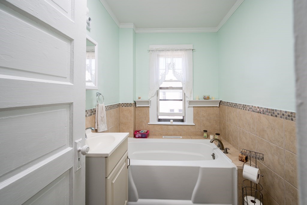 48 Bates Street Hull, MA 02045 - Photo 19 of 31 a bathroom with a tub sink and window