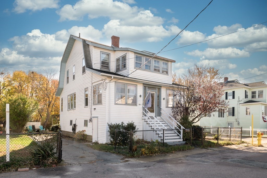 48 Bates Street Hull, MA 02045 - Photo 2 of 31 a view of a white building among the street with palm trees
