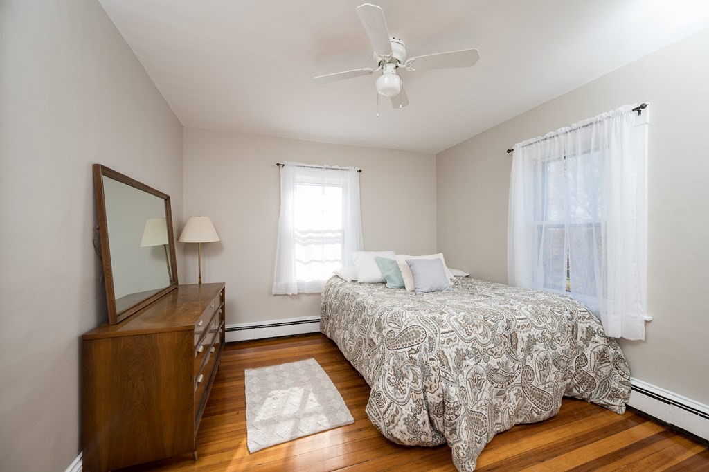 48 Bates Street Hull, MA 02045 - Photo 25 of 31 a bedroom with a bed and dresser with wooden floor