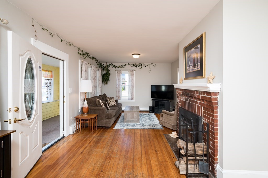 48 Bates Street Hull, MA 02045 - Photo 4 of 31 a living room with furniture and a fireplace
