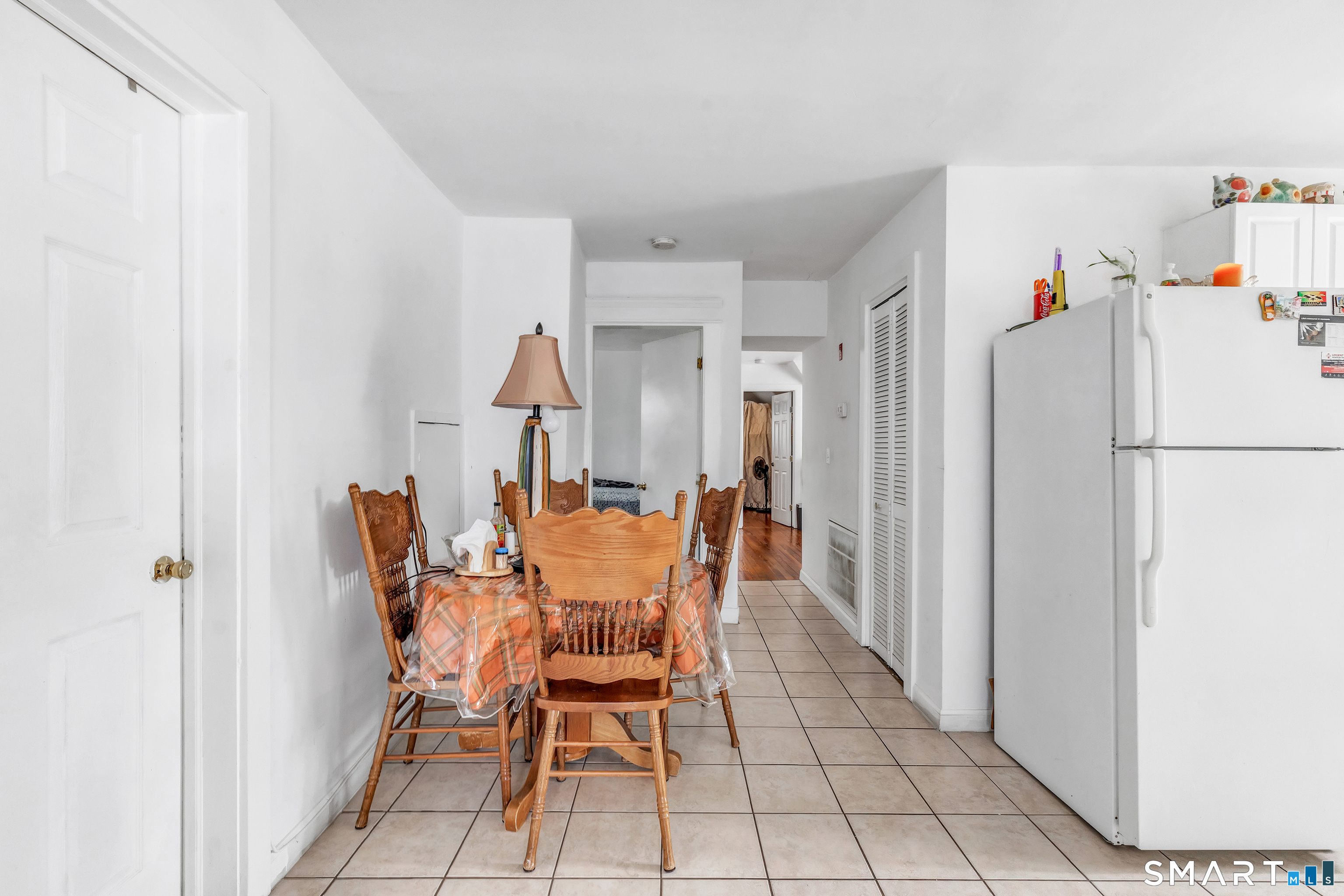 189 Wells Street Bridgeport, CT 06606 - Photo 27 of 40 3rd Floor - Offers 946 sq ft -Kitchen offers white cabinets, electric stove, fridge and washer/dryer