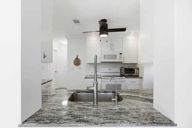 a bedroom with a bed and a chair with the bookshelf