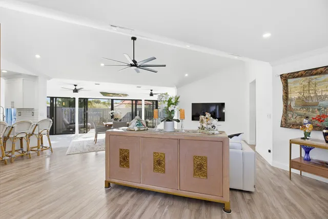 a bedroom with a large bed and a wooden floor