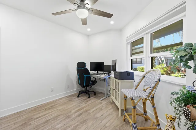 a backyard of a house with table and chairs under an umbrella