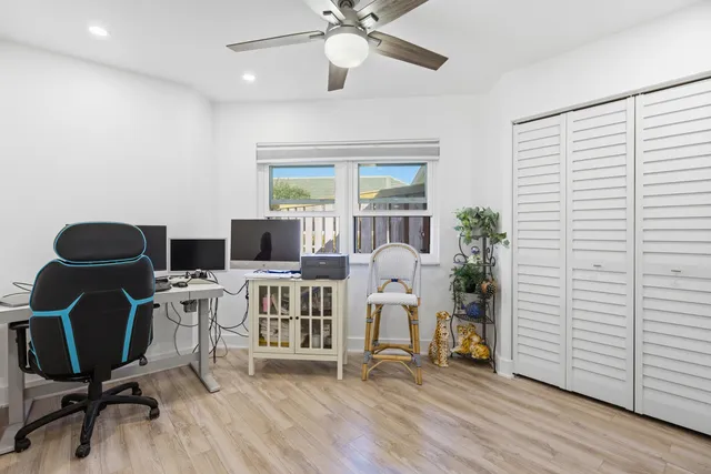 a view of a patio with a table and chairs under an umbrella