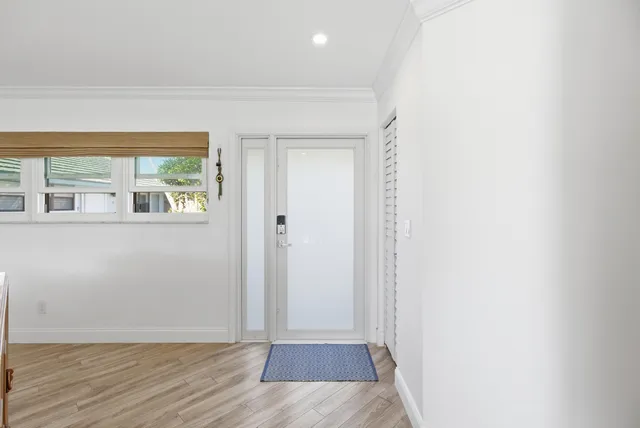 a bedroom with furniture and large windows