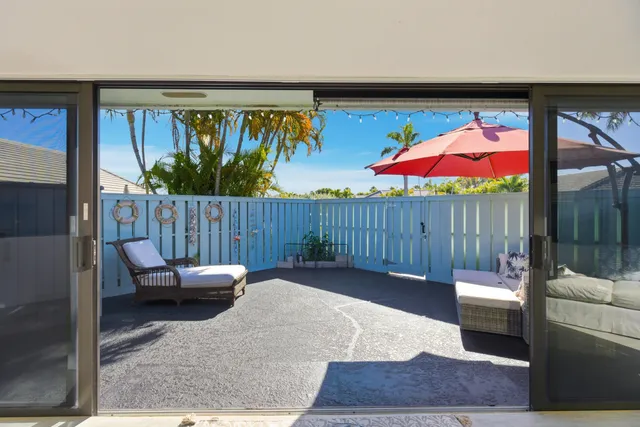 a view of a chairs and table in the balcony