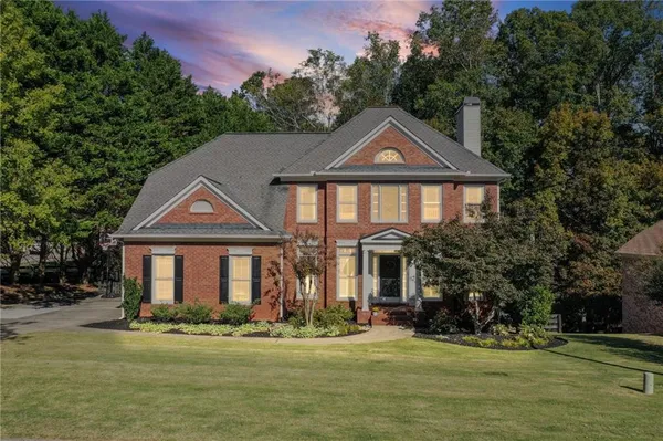 a front view of a house with a yard