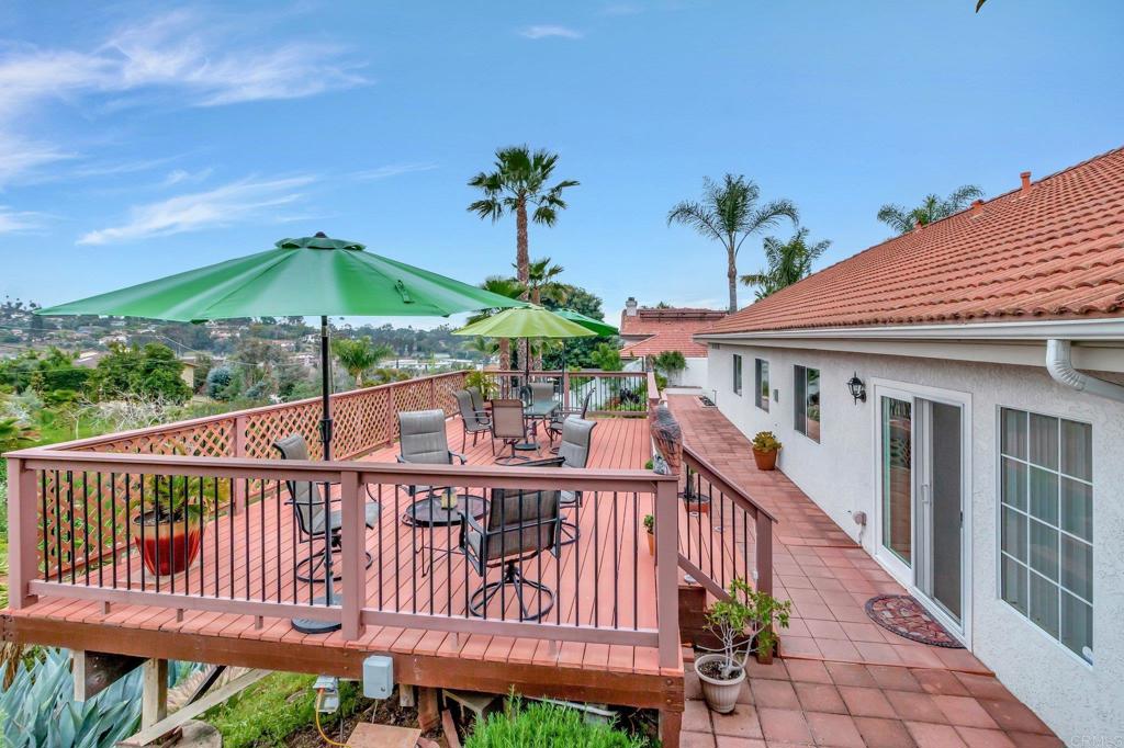1205 Rancho Pacifica Place Vista, CA 92084 - Photo 2 of 42 a view of a wooden house with a yard and furniture