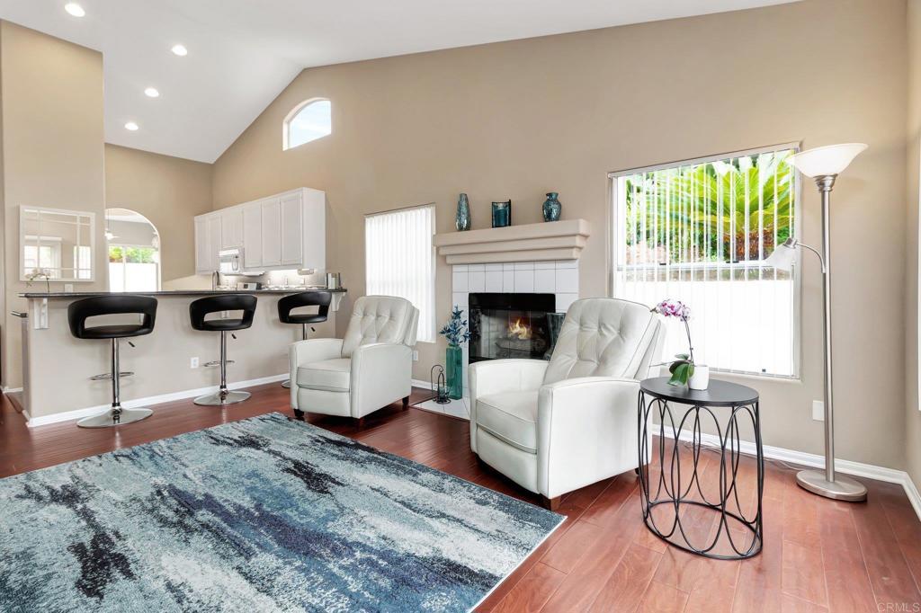 1205 Rancho Pacifica Place Vista, CA 92084 - Photo 28 of 42 a living room with furniture a fireplace and a table