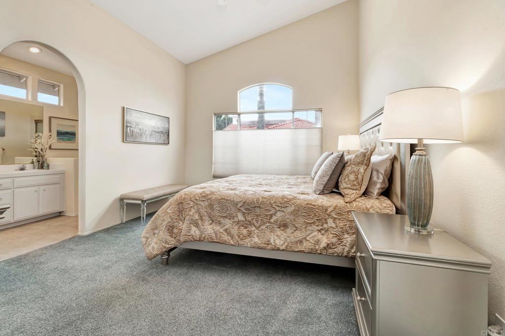1205 Rancho Pacifica Place Vista, CA 92084 - Photo 33 of 42 a bedroom with a bed and a lamp