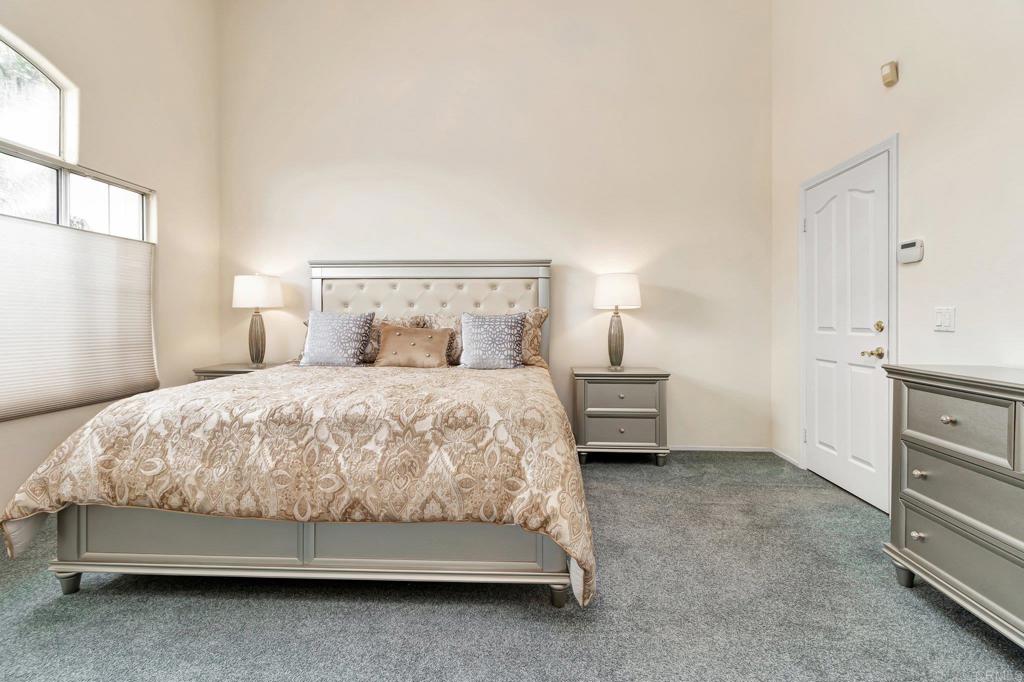 1205 Rancho Pacifica Place Vista, CA 92084 - Photo 35 of 42 a bed sitting in a bedroom next to a window