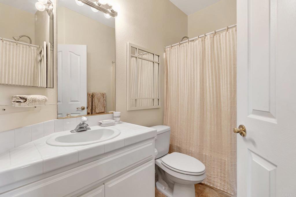 1205 Rancho Pacifica Place Vista, CA 92084 - Photo 39 of 42 a bathroom with a sink toilet and shower