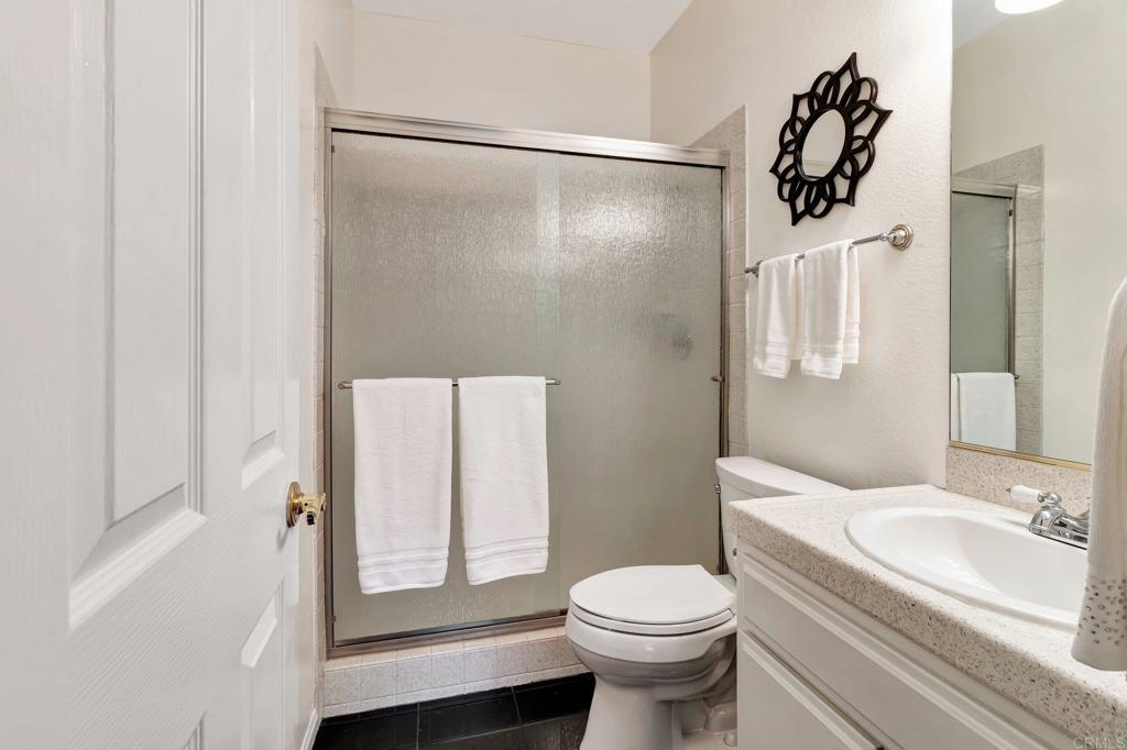 1205 Rancho Pacifica Place Vista, CA 92084 - Photo 42 of 42 a bathroom with a sink toilet and shower