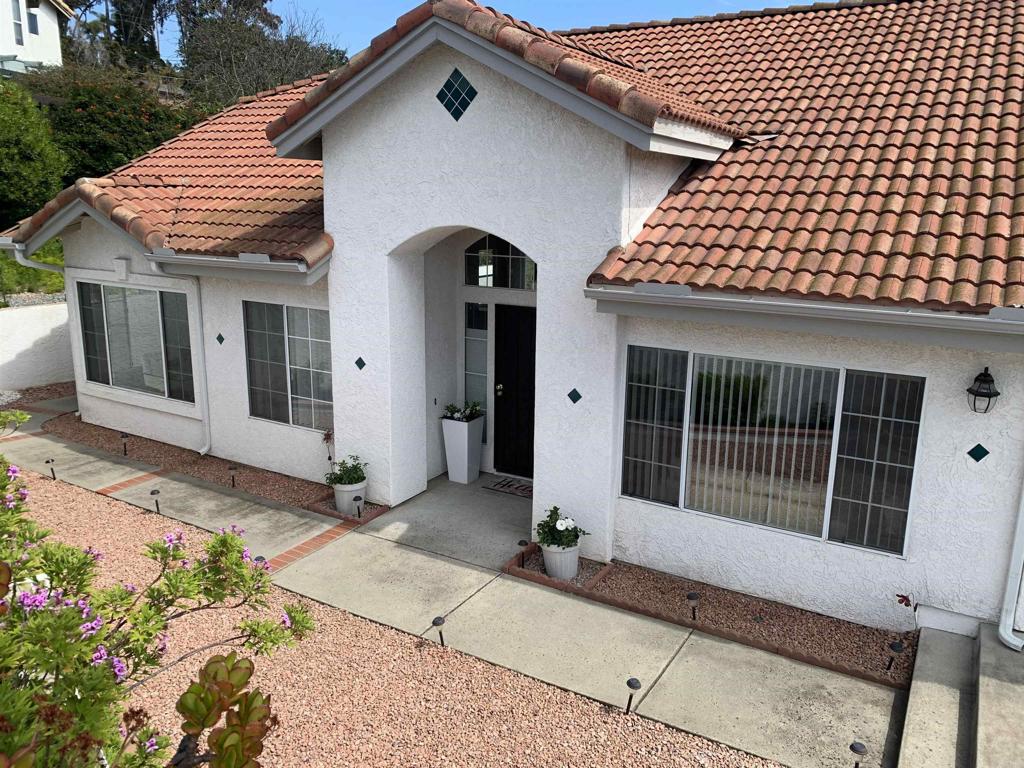 1205 Rancho Pacifica Place Vista, CA 92084 - Photo 5 of 42 a front view of a house with a garden