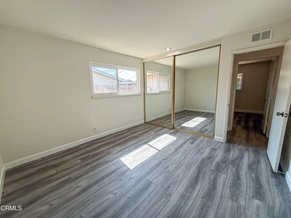 a view of a room with wooden floor