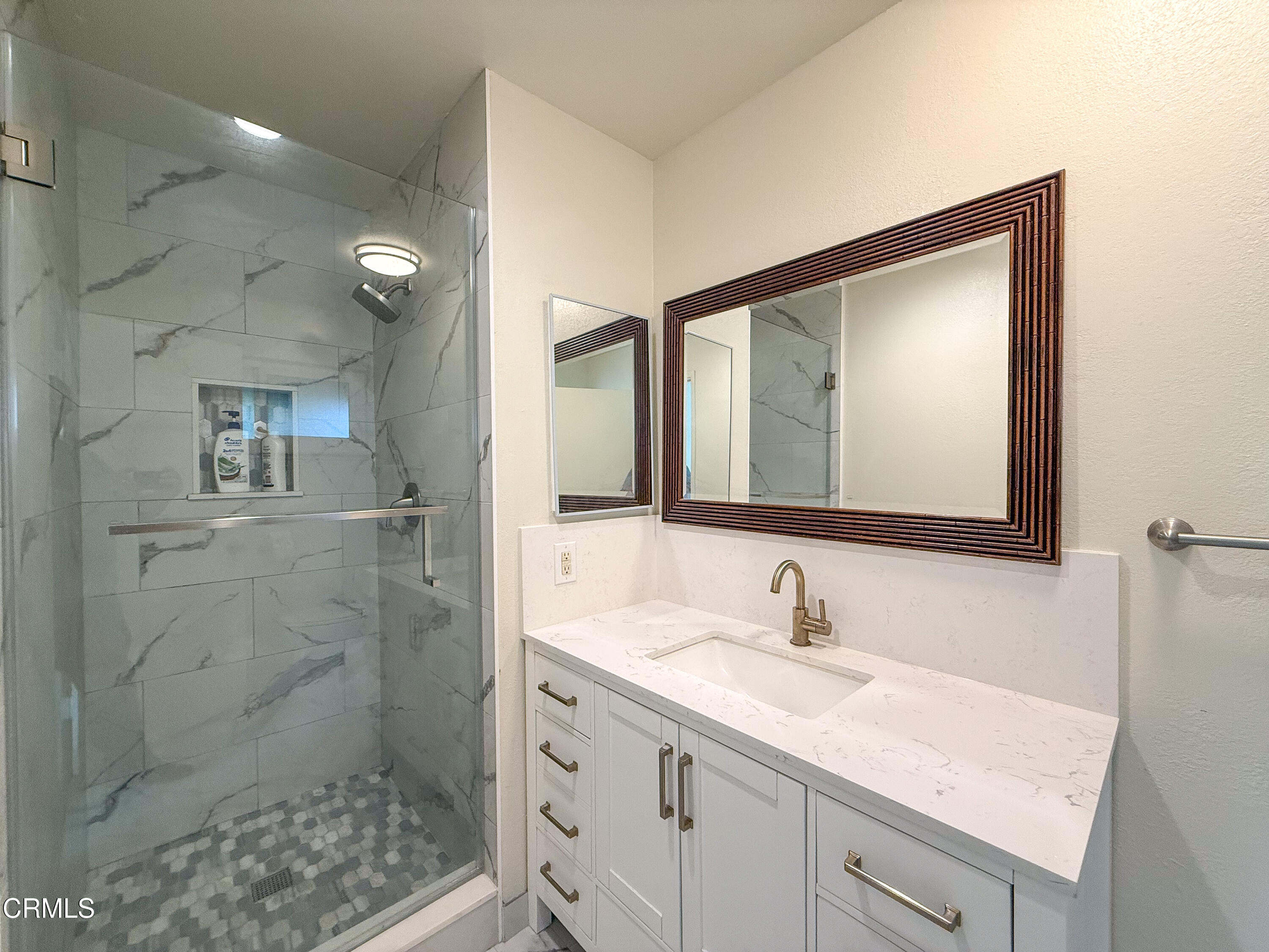 1730 West Hemlock Street Oxnard, CA 93035 - Photo 13 of 25 a bathroom with a sink shower and a mirror