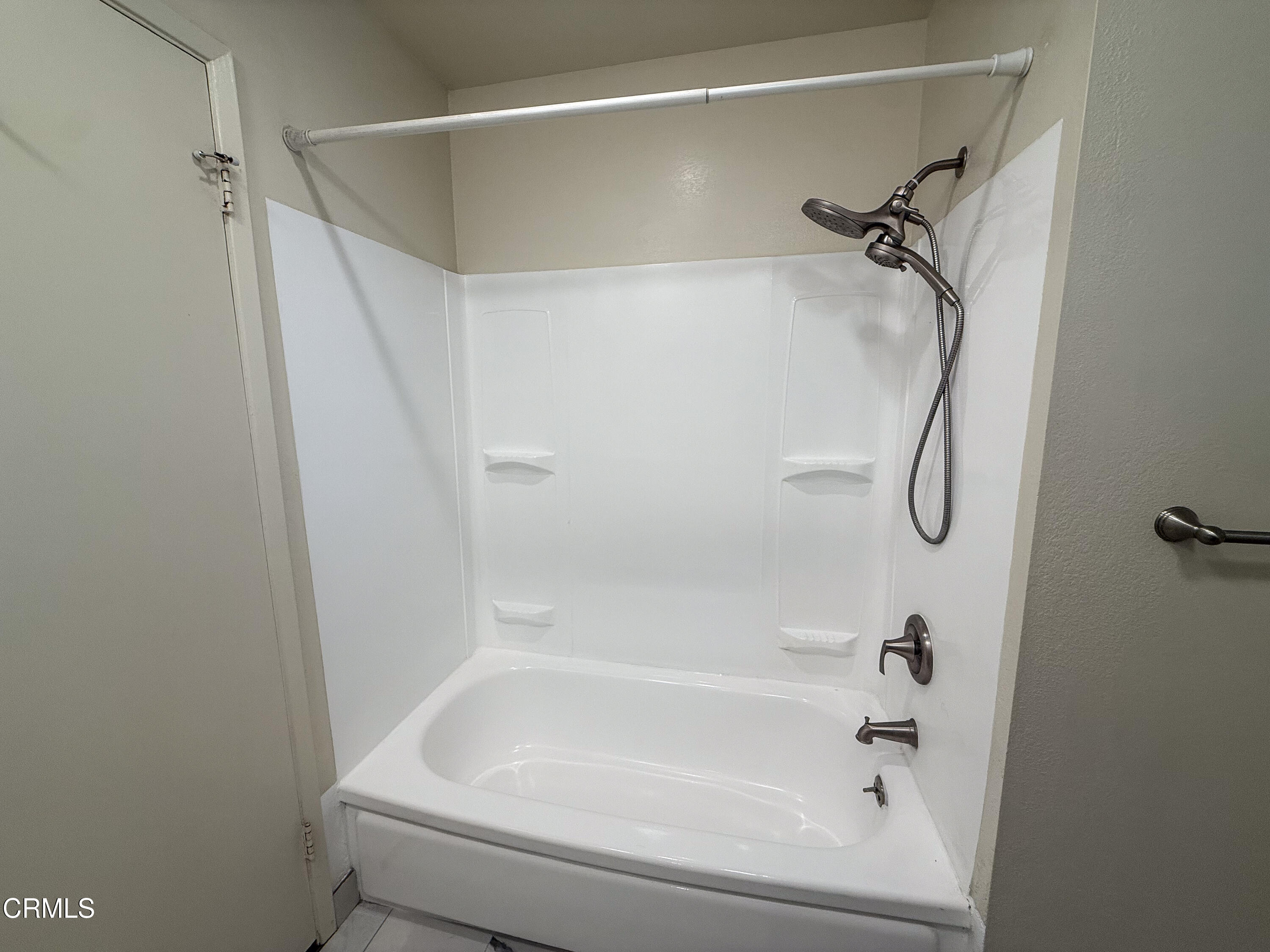 1730 West Hemlock Street Oxnard, CA 93035 - Photo 18 of 25 a bathroom with a bath tub with a shower