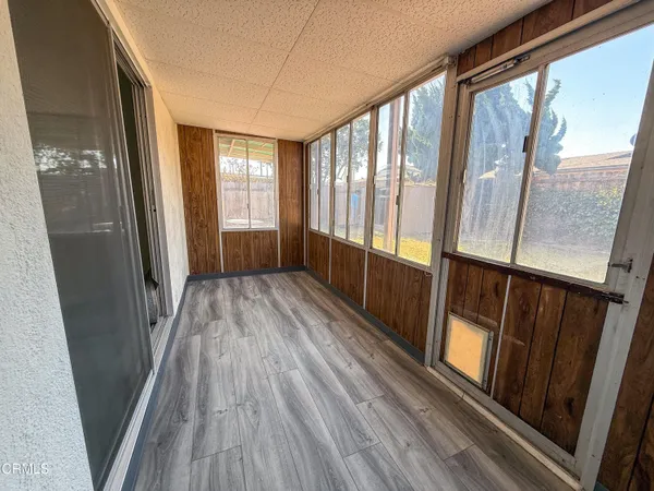 a view of a room with wooden floor and staircase