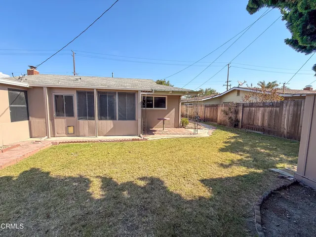 a swimming pool with yard in front of it