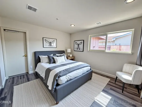 a bed room with a bed and a chair