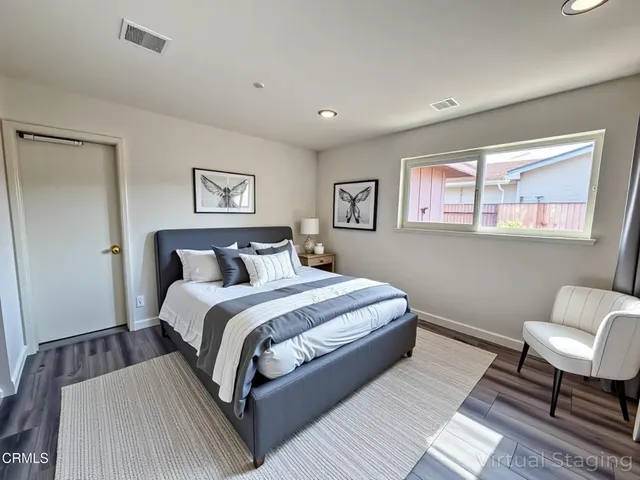 a bed room with a bed and a chair