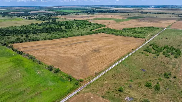 a view of a field with an ocean view