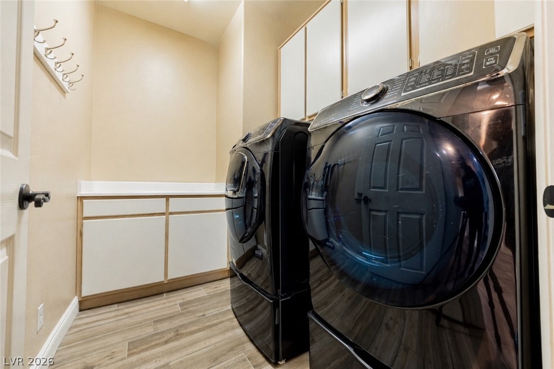 2504 Putting Green Drive Henderson, NV 89074 - Photo 38 of 56 Functional laundry space featuring modern appliances, ample storage, and durable flooring.