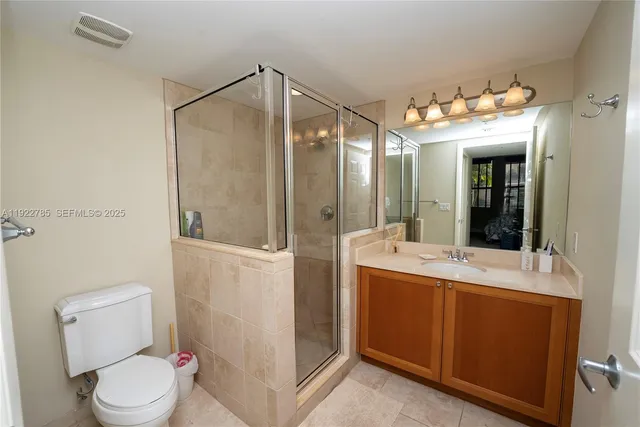 a living room with large couches and dining table with a large window