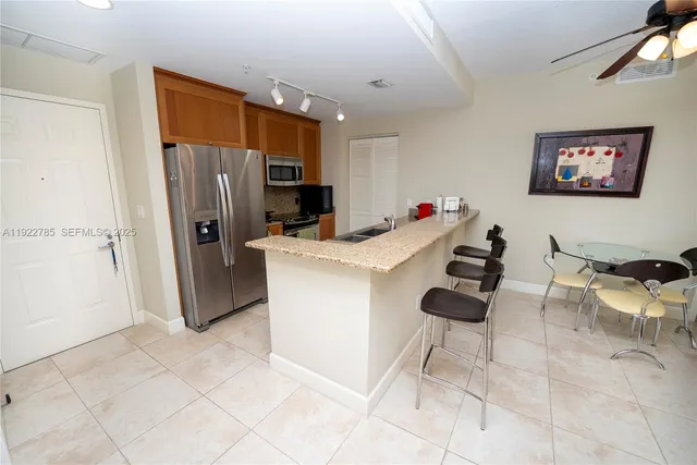a kitchen with granite countertop a sink appliances and cabinets
