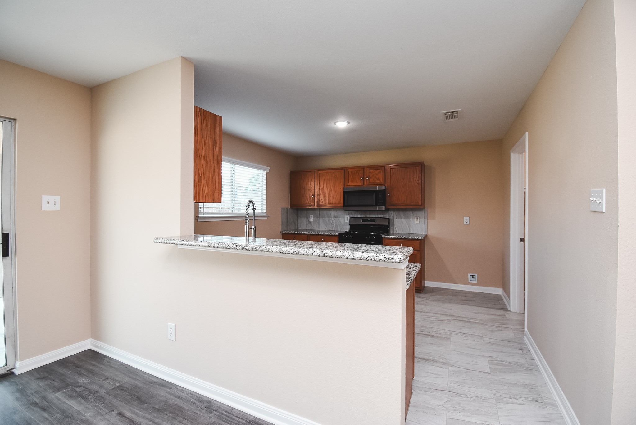20815 Baronsledge Lane Katy, TX 77449 - Photo 11 of 31 a kitchen with stainless steel appliances a sink stove and cabinets