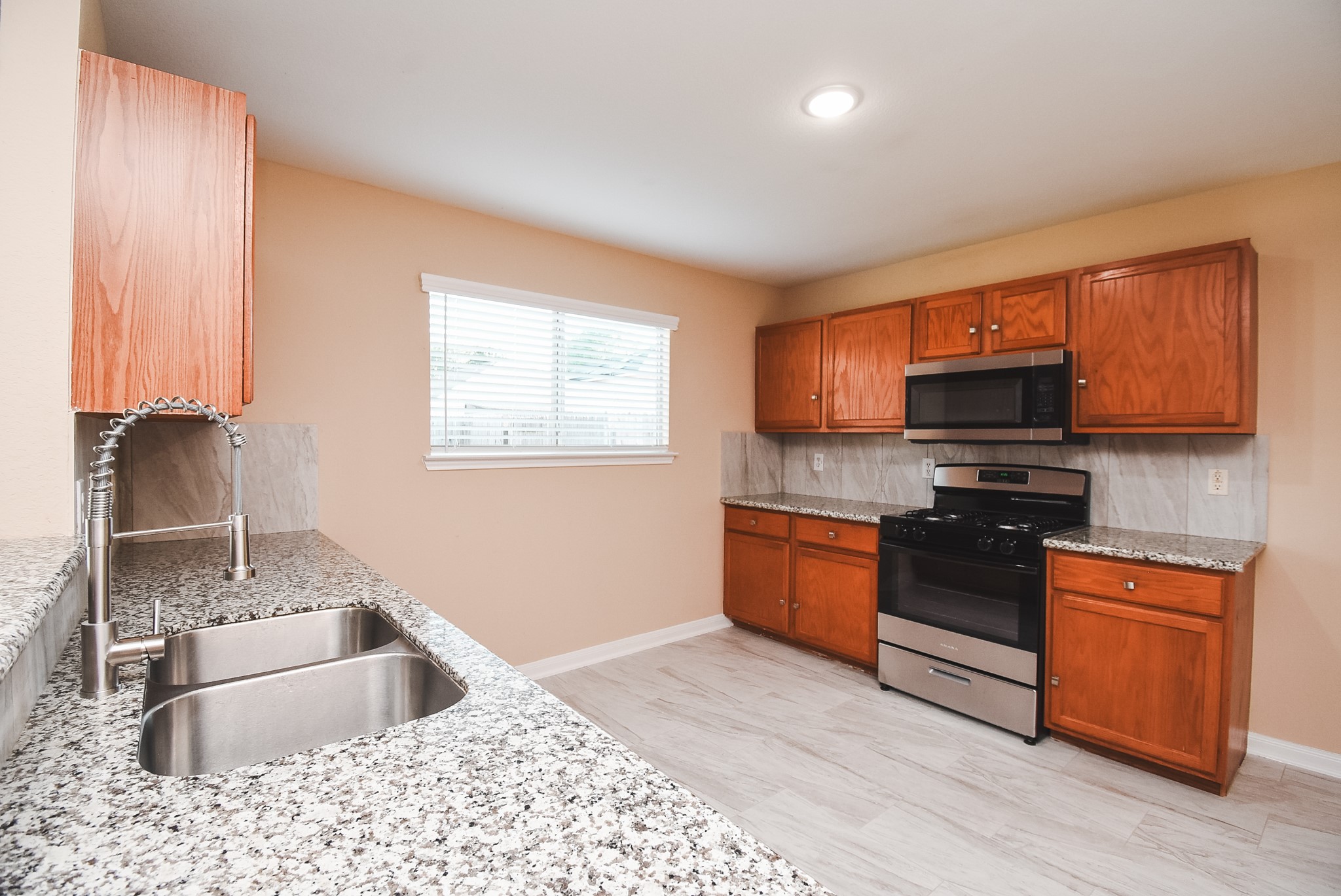 20815 Baronsledge Lane Katy, TX 77449 - Photo 12 of 31 a kitchen with stainless steel appliances granite countertop a sink stove and refrigerator