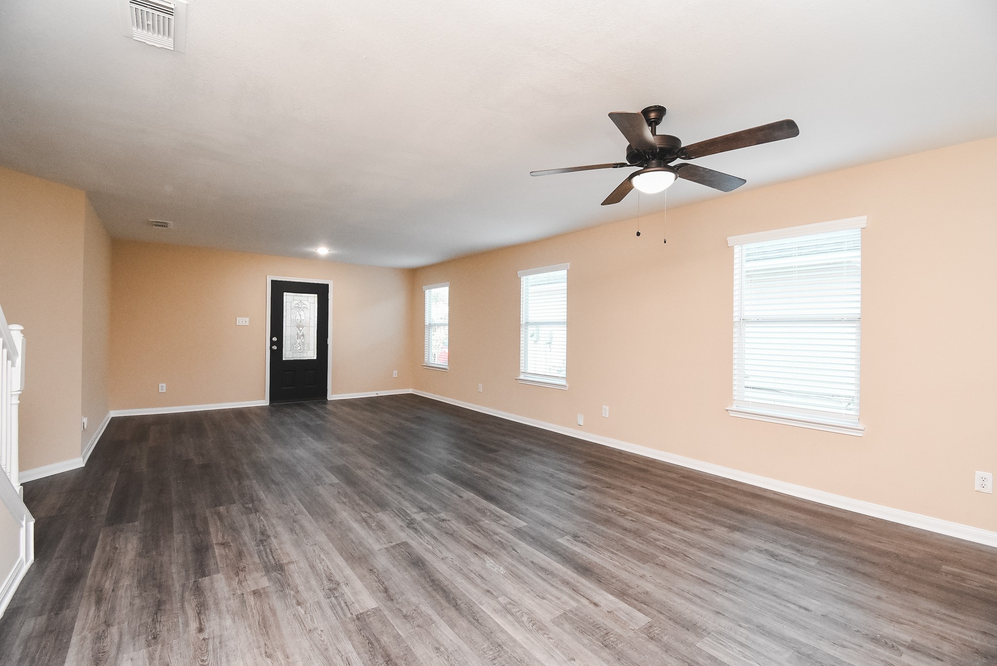 20815 Baronsledge Lane Katy, TX 77449 - Photo 2 of 31 a view of an empty room with a window and wooden floor