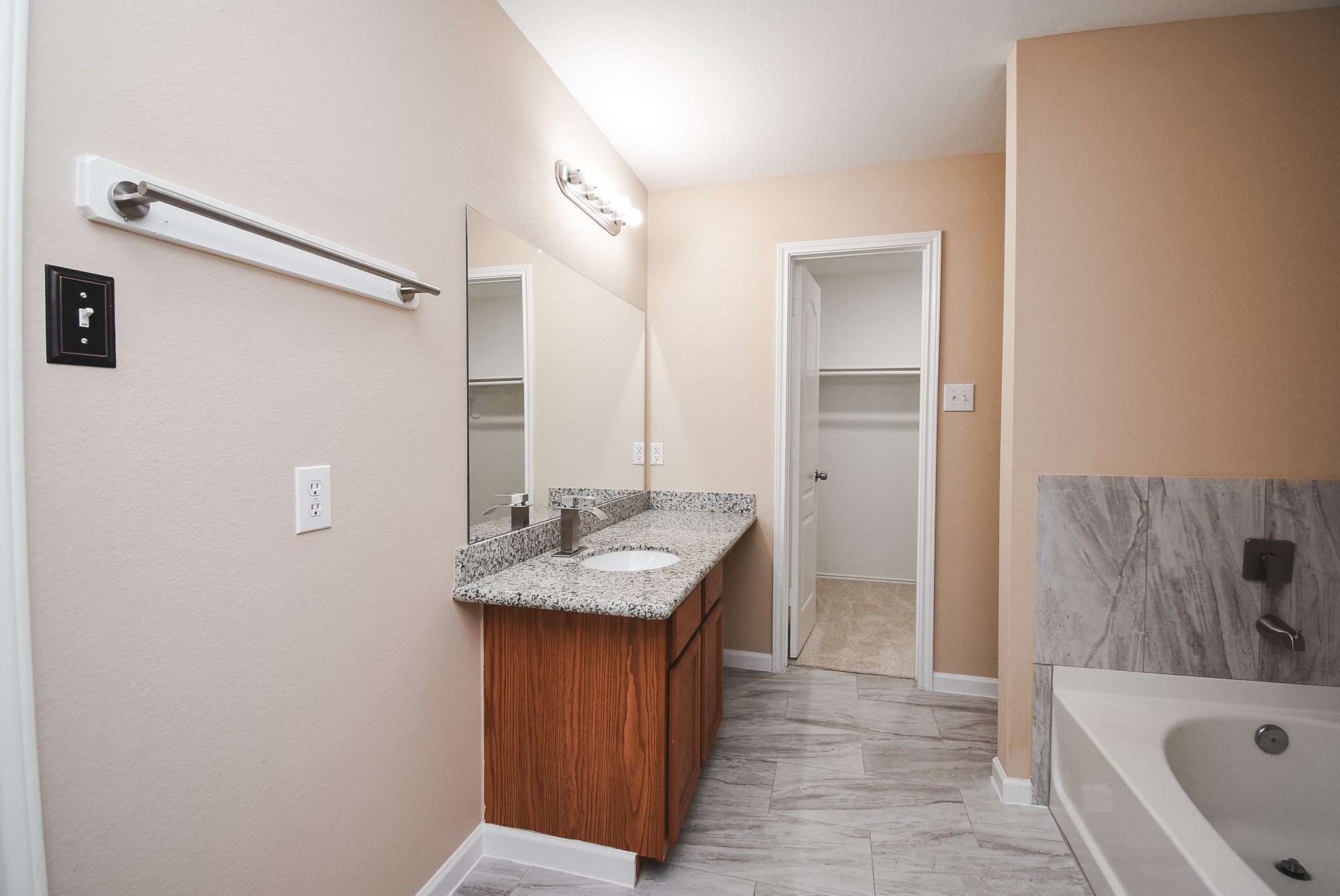 20815 Baronsledge Lane Katy, TX 77449 - Photo 23 of 31 a bathroom with a granite countertop sink and a bathtub