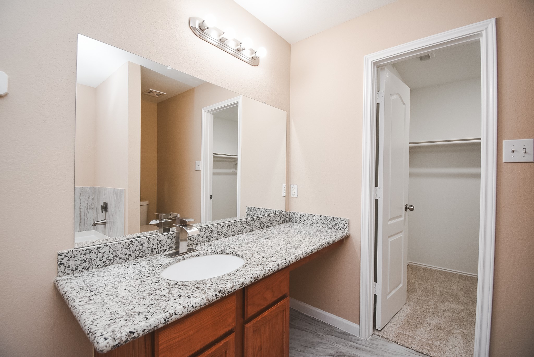 20815 Baronsledge Lane Katy, TX 77449 - Photo 26 of 31 a bathroom with a granite countertop sink and a mirror