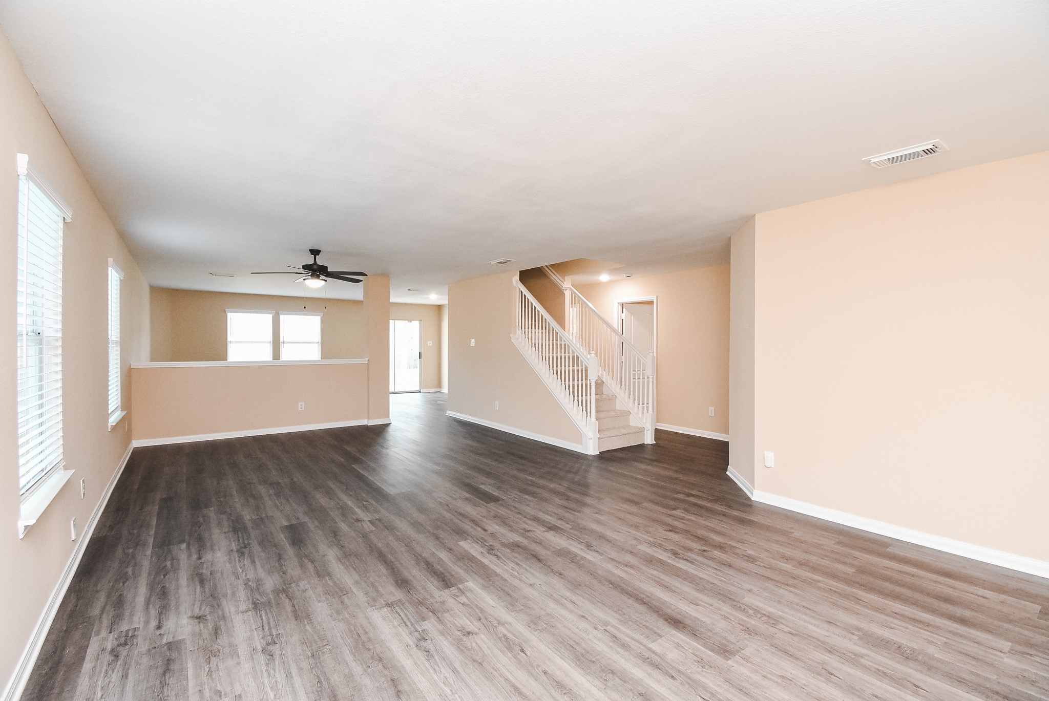20815 Baronsledge Lane Katy, TX 77449 - Photo 4 of 31 an empty room with wooden floor and windows