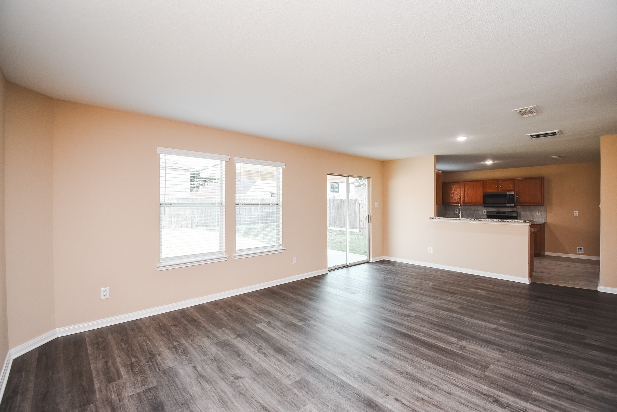 20815 Baronsledge Lane Katy, TX 77449 - Photo 6 of 31 an empty room with wooden floor and windows