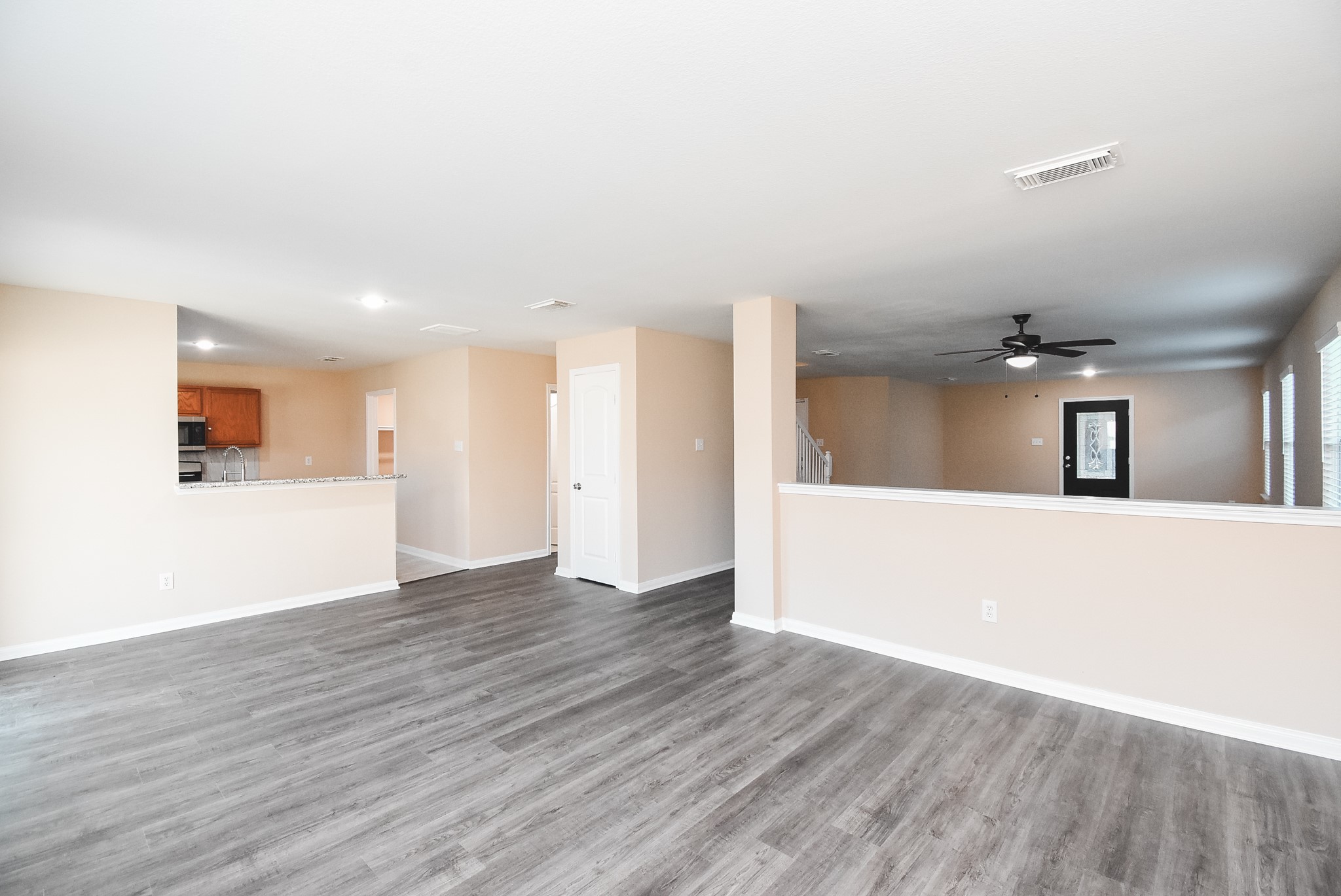20815 Baronsledge Lane Katy, TX 77449 - Photo 8 of 31 a view of a big room with wooden floor and windows