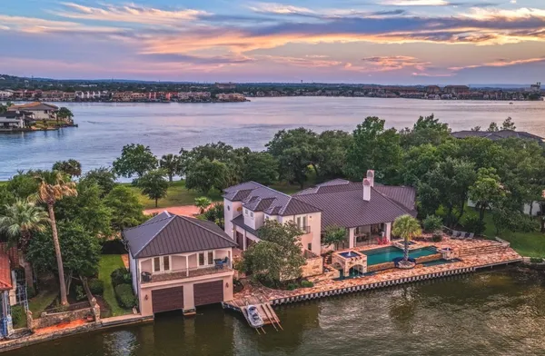 an aerial view of house with yard and lake view