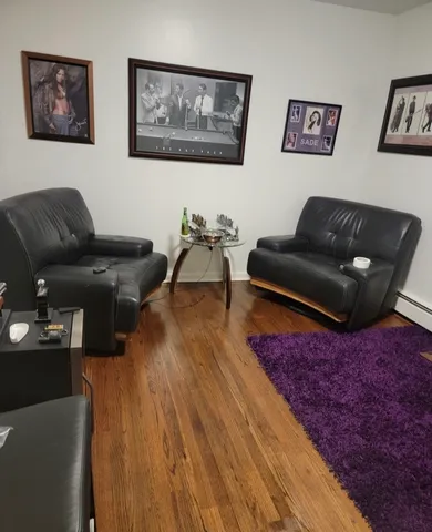 a living room with furniture and wooden floor