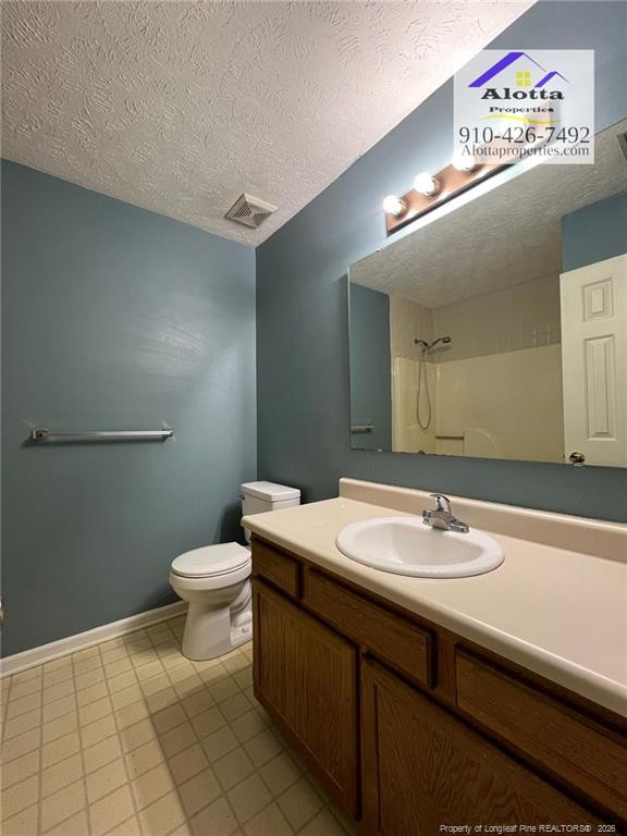 732 Rim Road Fayetteville, NC 28314 - Photo 13 of 17 a bathroom with a sink a toilet and a mirror